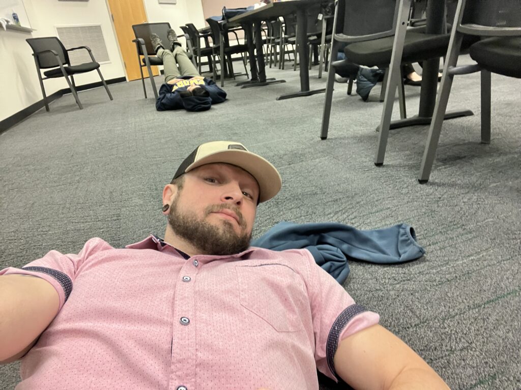 Laying on UM Business school classroom floor in marketing class